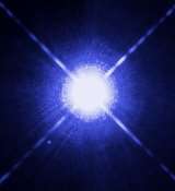 This Hubble Space Telescope image shows Sirius A, the brightest star in our nighttime sky, along with its faint, tiny stellar companion, Sirius B. Astronomers overexposed the image of Sirius A [at centre] so that the dim Sirius B [tiny dot at lower left] could be seen. The cross-shaped diffraction spikes and concentric rings around Sirius A, and the small ring around Sirius B, are artifacts produced within the telescope's imaging system. The two stars revolve around each other every 50 years. Sirius A, only 8.6 light-years from Earth, is the fifth closest star system known. Sirius B, a white dwarf, is very faint because of its tiny size, only 12,000 kilometres in diameter. White dwarfs are the leftover remnants of stars similar to our Sun. They have exhausted their nuclear fuel sources and have collapsed down to a very small size. Sirius B is about 10,000 times fainter than Sirius A. The white dwarf's feeble light makes it a challenge to study, because its light is swamped in the glare of its brighter companion as seen from telescopes on Earth. However, using the keen eye of Hubble's Space Telescope Imaging Spectrograph (STIS), astronomers have now been able to isolate the light from Sirius B and disperse it into a spectrum. STIS measured light from Sirius B being stretched to longer, redder wavelengths due to the white dwarf's powerful gravitational pull. Based on those measurements, astronomers have calculated Sirius B's mass at 98 percent that of our Sun. Analysis of the white dwarf's spectrum also has allowed astronomers to refine the estimate for its surface temperature to about 25,000 C.   Accurately determining the masses of white dwarfs is fundamentally important to understanding stellar evolution. Our Sun will eventually become a white dwarf. White dwarfs are also the source of Type Ia supernova explosions, which are used to measure cosmological distances and the expansion rate of the universe. Measurements based on Type Ia supernovae are fundamental to understanding "dark energy" , a dominant repulsive force stretching the universe apart. Also, the method used to determine the white dwarf's mass relies on one of the key predictions of Einstein's theory of General Relativity: that light loses energy when it attempts to escape the gravity of a compact star. This image was taken 15 Oct., 2003, with Hubble's Wide Field Planetary Camera 2. Based on detailed measurements of the position of Sirius B in this image, astronomers were then able to point the STIS instrument exactly on the white dwarf and make the measurements to determine its gravitational redshift and mass.